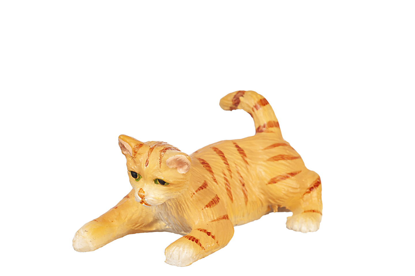 Orange striped cat with green eyes figurine, in a crouched playful position, on a white background