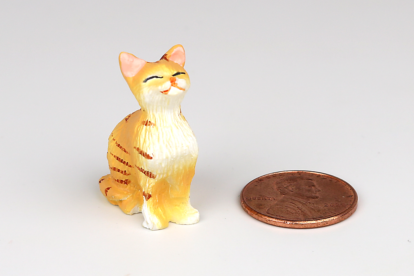 Sitting Orange Cat with Eyes Closed
