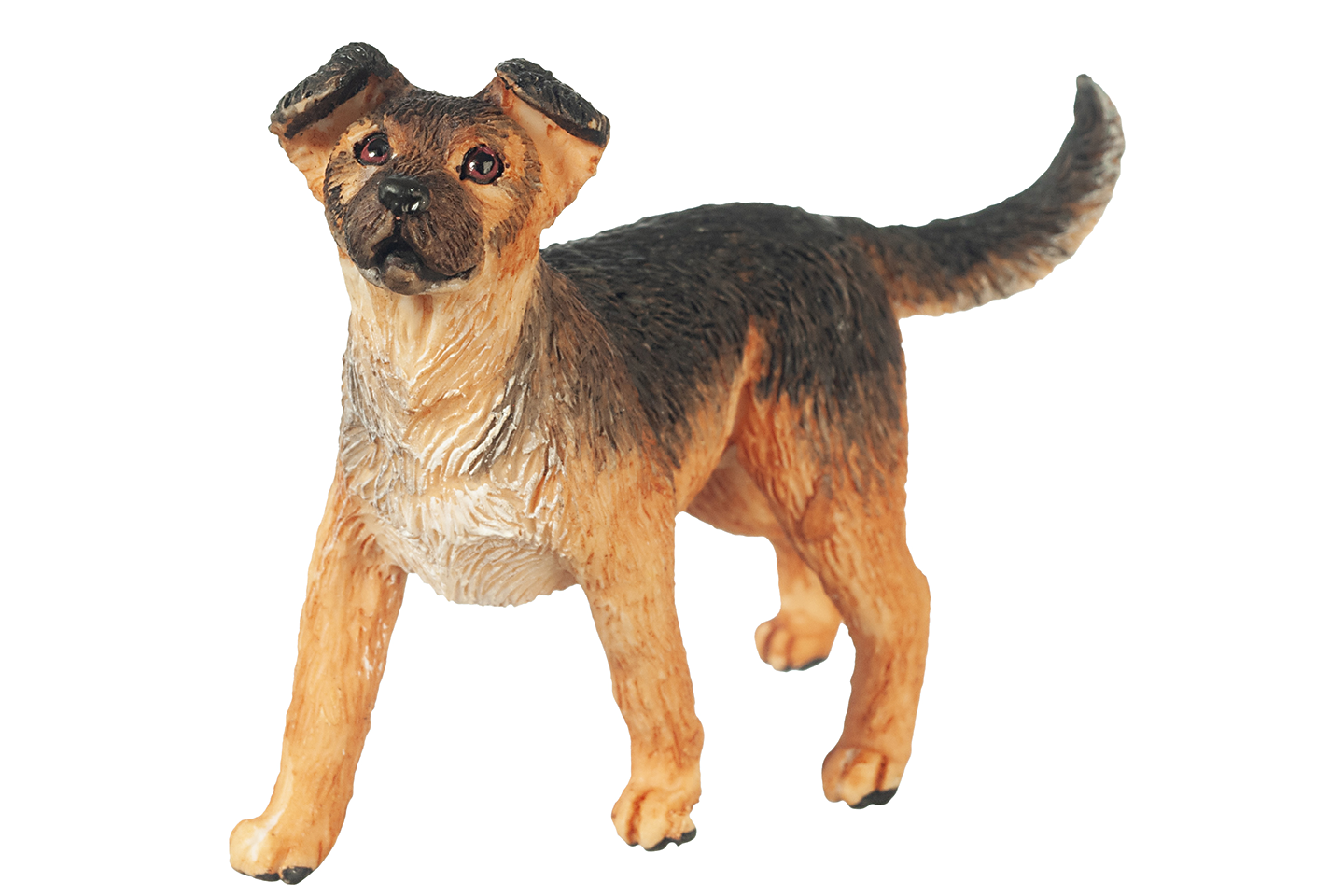 Dog figurine with a brown and black coat on a white background