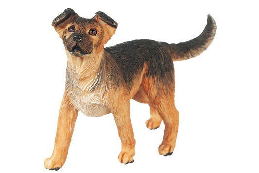 Dog figurine with a brown and black coat on a white background