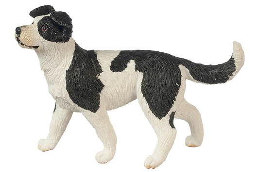 Black and white dog figurine on a white background