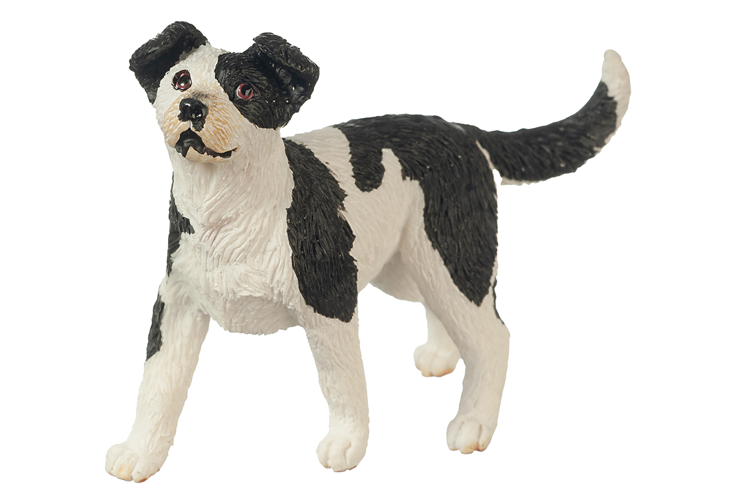 Black and white dog figurine on a white background