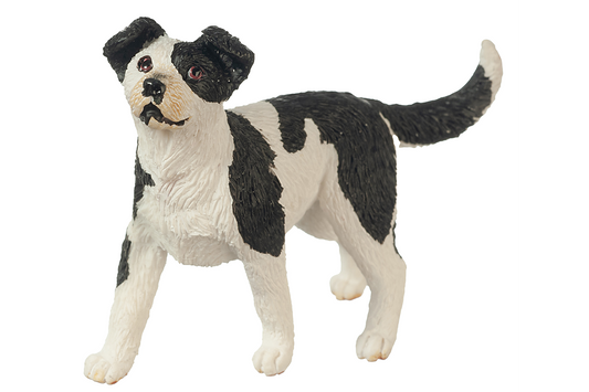 Black and white dog figurine on a white background