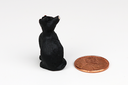 Sitting Black Cat with Eyes Closed